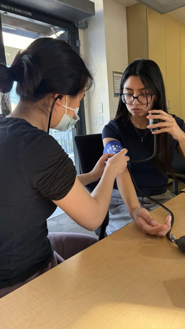 SDIPP volunteers practice measuring vital signs with certified EMTs